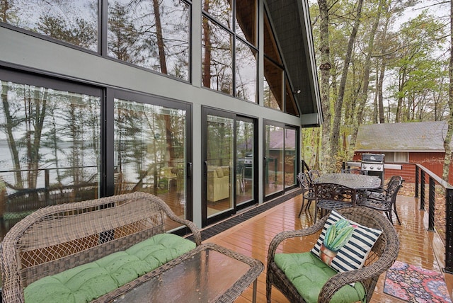 sunroom with plenty of natural light and outdoor dining space