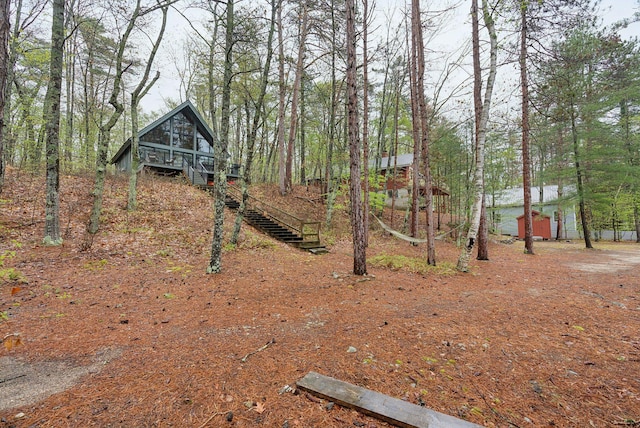 view of yard with an outbuilding and stairway