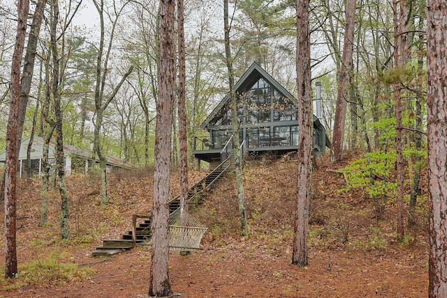 back of property featuring a deck and stairway