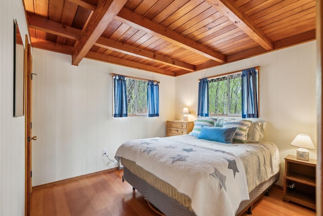 bedroom with wooden ceiling, beamed ceiling, and multiple windows