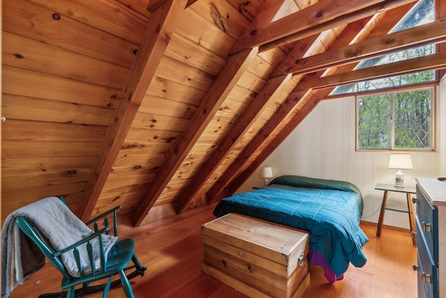 bedroom featuring wood ceiling, light wood-style flooring, and vaulted ceiling with beams
