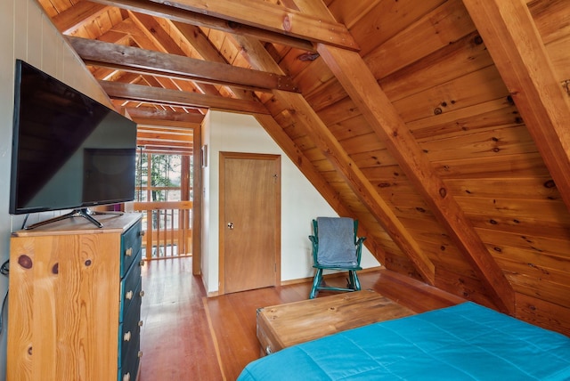 bedroom featuring wooden ceiling, lofted ceiling with beams, and wood finished floors