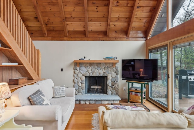 living area with wood ceiling, wood finished floors, lofted ceiling with beams, and a fireplace