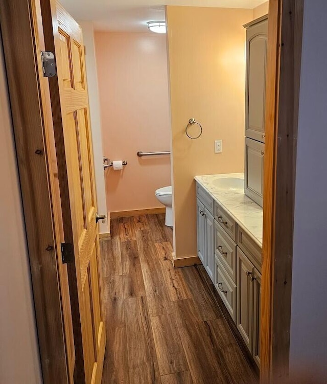 277 Grant Rd, Saint Albans, ME 04971 - bathroom featuring vanity, baseboards, toilet, and wood finished floors