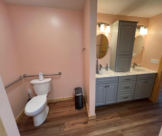 277 Grant Rd, Saint Albans, ME 04971 - bathroom with toilet, wood finished floors, double vanity, and a sink