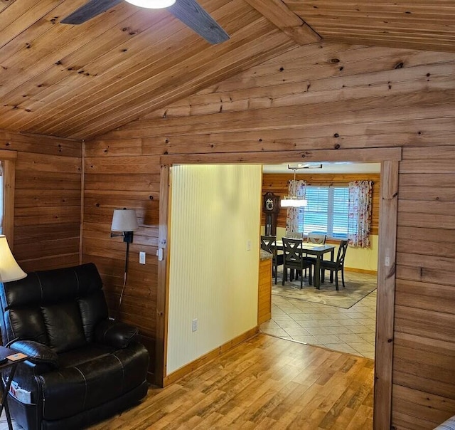 277 Grant Rd, Saint Albans, ME 04971 - living area featuring wooden walls, baseboards, and lofted ceiling