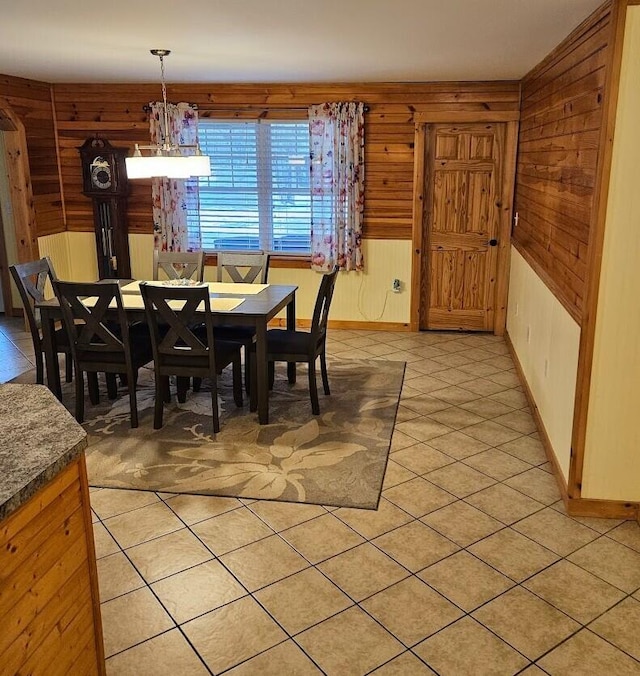 277 Grant Rd, Saint Albans, ME 04971 - dining room featuring wood walls, baseboards, and light tile patterned floors