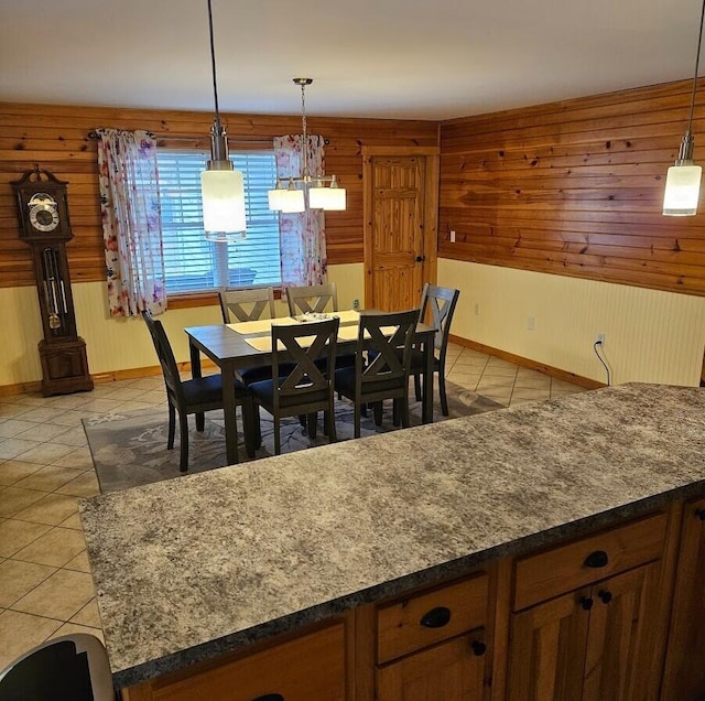 277 Grant Rd, Saint Albans, ME 04971 - dining room with light tile patterned floors, baseboards, wooden walls, and a notable chandelier