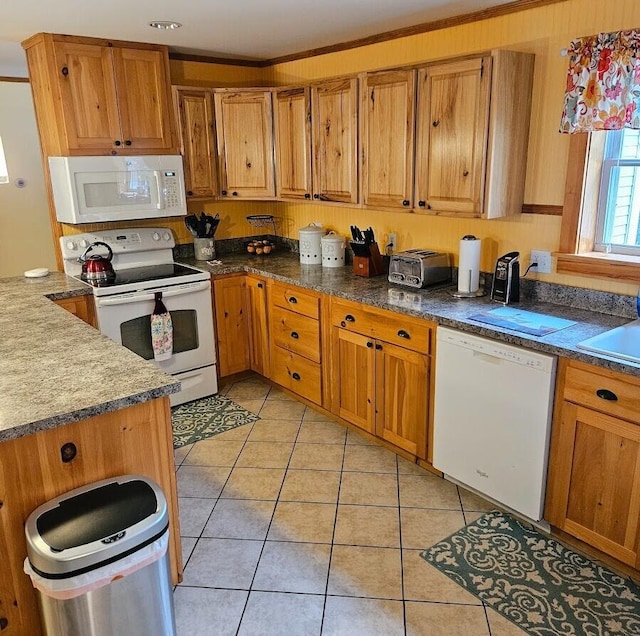 277 Grant Rd, Saint Albans, ME 04971 - kitchen featuring white appliances, brown cabinetry, light tile patterned floors, and dark countertops