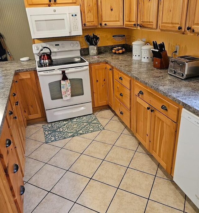 277 Grant Rd, Saint Albans, ME 04971 - kitchen featuring a toaster, white appliances, brown cabinetry, and light tile patterned floors