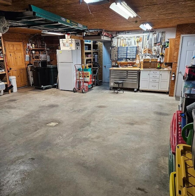 277 Grant Rd, Saint Albans, ME 04971 - garage with freestanding refrigerator and a workshop area