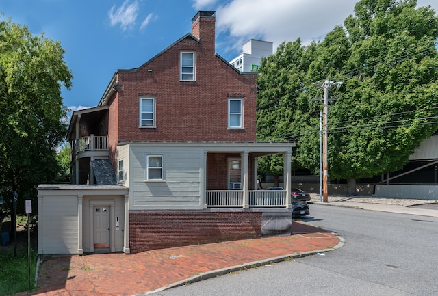 68 Pleasant St, Portland, ME 04101 - view of front of home with a balcony, brick siding, and covered porch