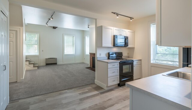 68 Pleasant St, Portland, ME 04101 - kitchen featuring light countertops, a sink, track lighting, and black appliances