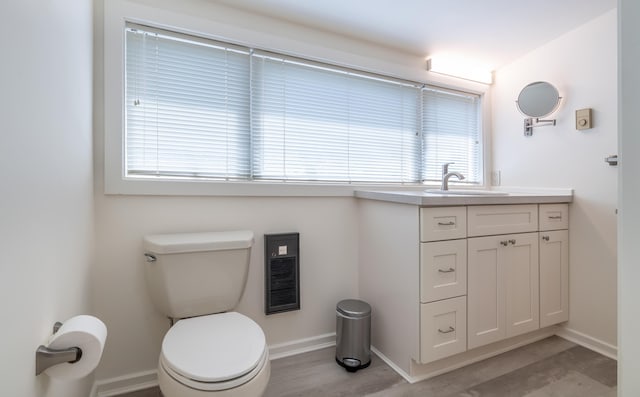 68 Pleasant St, Portland, ME 04101 - bathroom featuring baseboards, toilet, vanity, and wood finished floors