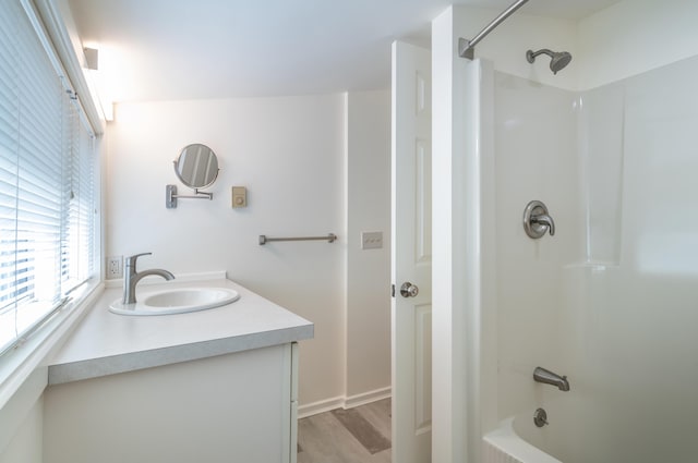 68 Pleasant St, Portland, ME 04101 - bathroom with tub / shower combination, wood finished floors, and vanity