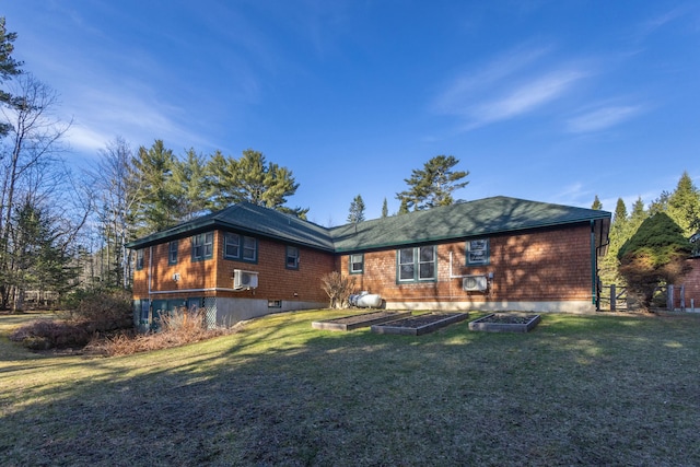 rear view of property with a yard, cooling unit, and a vegetable garden