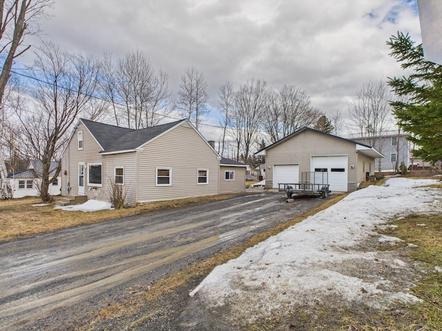 45 Crosby Ave, Caribou, ME 04736 - view of snow covered exterior featuring an outbuilding and a garage