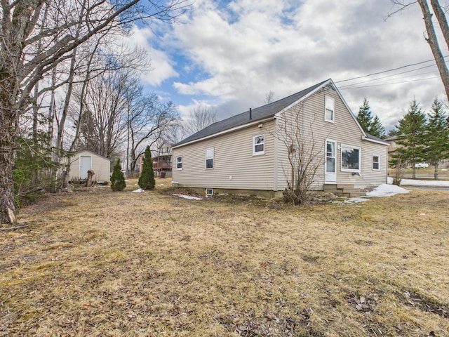 45 Crosby Ave, Caribou, ME 04736 - view of side of property with a storage shed, an outbuilding, and a lawn