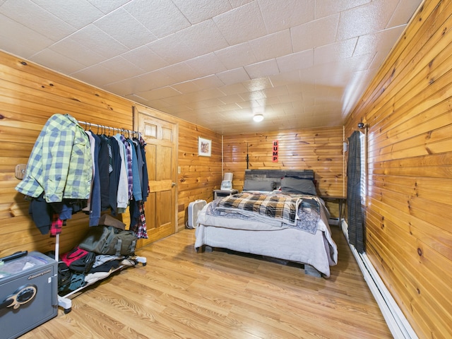 45 Crosby Ave, Caribou, ME 04736 - bedroom with light wood-type flooring, wood walls, and a baseboard heating unit