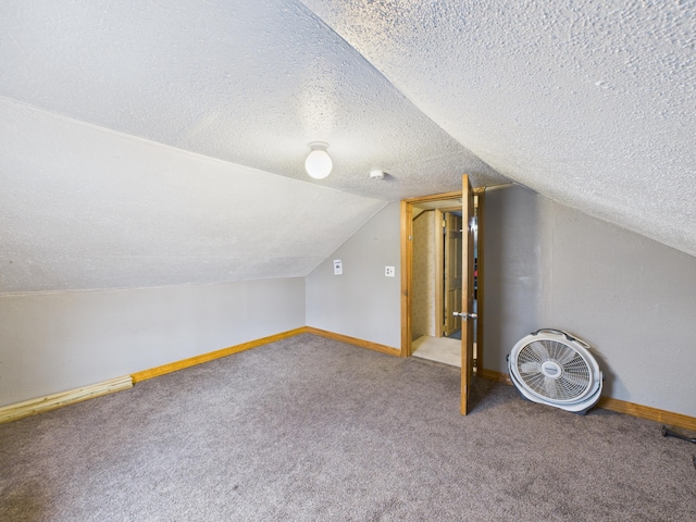 45 Crosby Ave, Caribou, ME 04736 - additional living space with a textured ceiling, baseboards, vaulted ceiling, and carpet floors