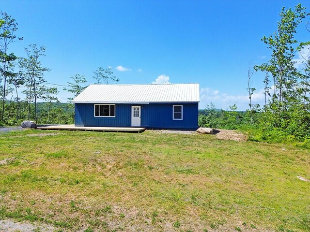 55 Emery Rd, Starks, ME 04911 - rear view of property with a metal roof and a yard