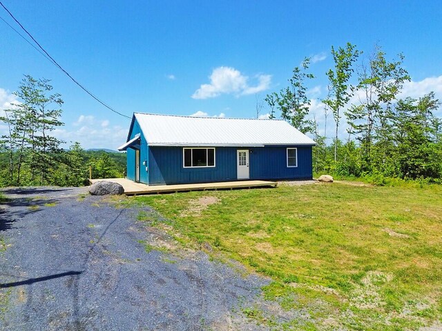 55 Emery Rd, Starks, ME 04911 - view of front of house with a front lawn and a metal roof