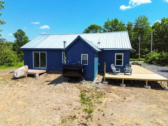 55 Emery Rd, Starks, ME 04911 - back of house with a wooden deck, heating fuel, and a metal roof
