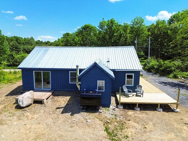 55 Emery Rd, Starks, ME 04911 - rear view of property with a deck and a metal roof