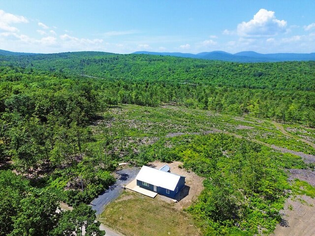 55 Emery Rd, Starks, ME 04911 - aerial view of property and surrounding area with a heavily wooded area and a mountainous background