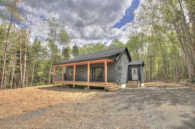 13 Quimby Farms Rd, Rangeley, ME 04970 - view of front of property featuring dirt driveway, a shingled roof, and a porch