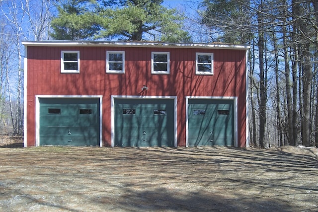 garage with a detached garage and driveway