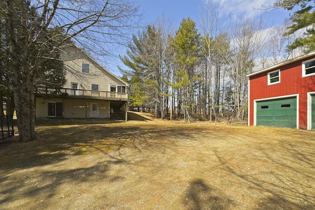 view of yard with driveway and a wooden deck