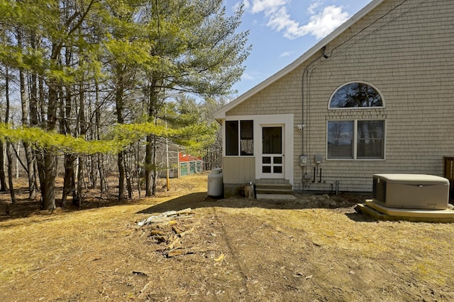 rear view of house featuring entry steps