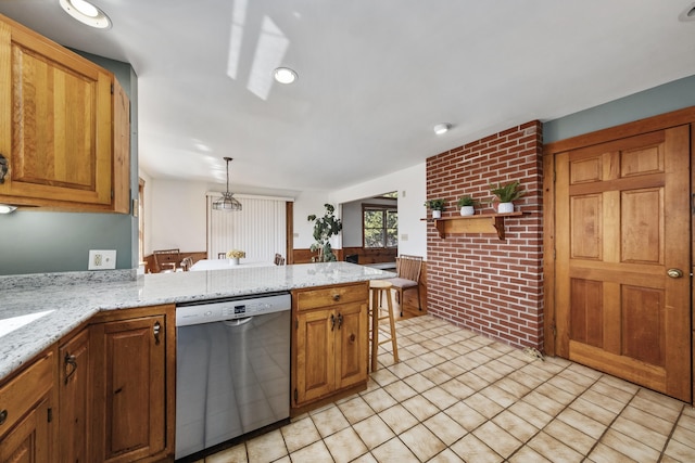 kitchen with light tile patterned floors, stainless steel dishwasher, a peninsula, and light stone countertops