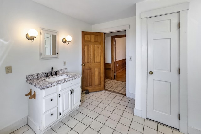 bathroom with tile patterned floors, vanity, and baseboards