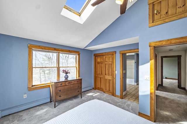 bedroom with a baseboard radiator, carpet flooring, baseboards, and a skylight