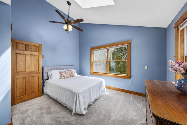 carpeted bedroom featuring high vaulted ceiling, baseboards, a ceiling fan, and a skylight