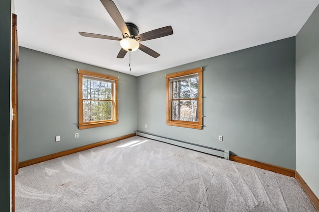 unfurnished room with a ceiling fan, a baseboard heating unit, baseboards, and carpet flooring
