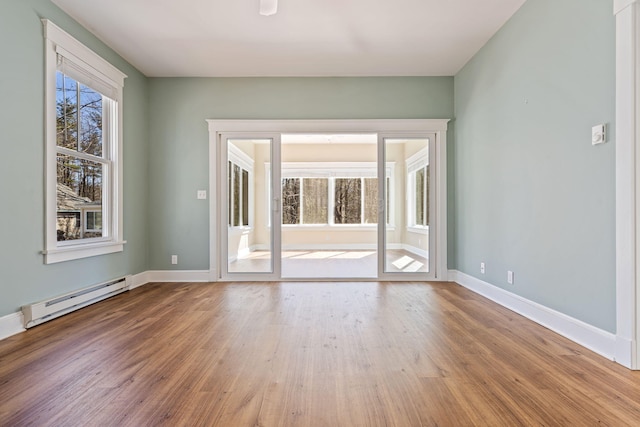1 Old County Rd Unit 140, Wells, ME 04090 - empty room featuring baseboards, a baseboard heating unit, and wood finished floors