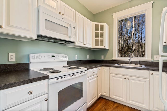 1 Old County Rd Unit 140, Wells, ME 04090 - kitchen with white appliances, dark countertops, glass insert cabinets, and a sink
