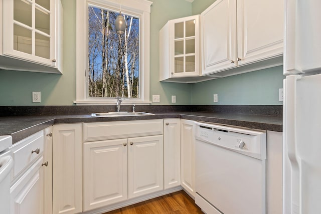 1 Old County Rd Unit 140, Wells, ME 04090 - kitchen featuring white cabinets, a sink, dark countertops, and white appliances