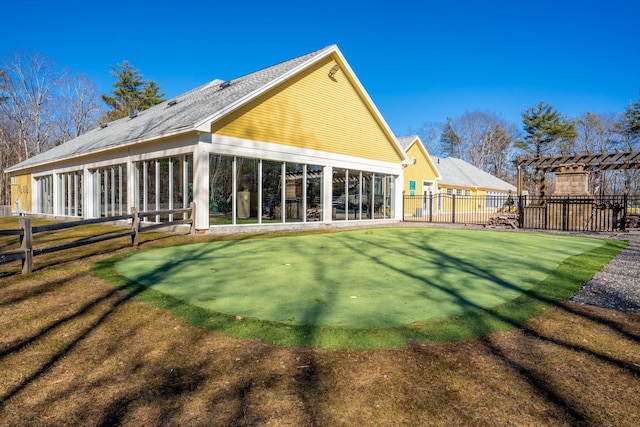 1 Old County Rd Unit 140, Wells, ME 04090 - rear view of house with a lawn, a sunroom, fence, and a pergola