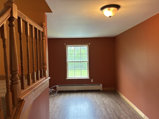 142 Abbott Rd, Albion, ME 04910 - spare room featuring a baseboard radiator, wood finished floors, stairs, and baseboards