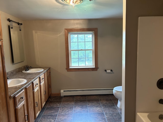 142 Abbott Rd, Albion, ME 04910 - full bath featuring a baseboard heating unit, toilet, double vanity, stone finish flooring, and shower / tub combination
