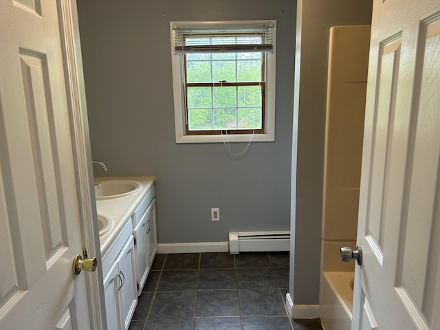 142 Abbott Rd, Albion, ME 04910 - bathroom featuring a baseboard radiator, double vanity, baseboards,  shower combination, and tile patterned floors