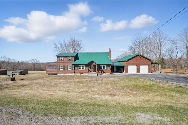 77 Huffs Corner Rd, Wellington, ME 04942 - view of front of property with a front yard, a garage, metal roof, driveway, and a chimney
