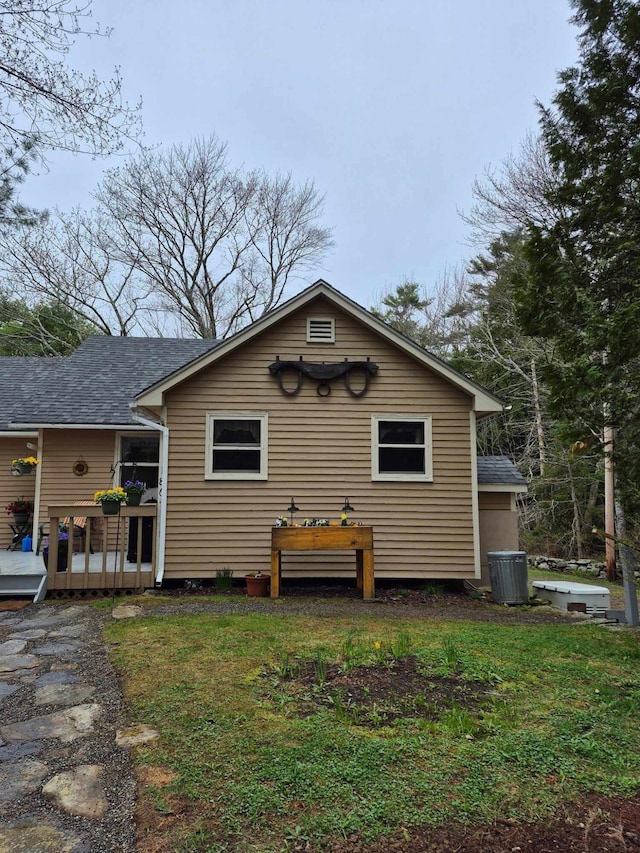 186 Hawes Ln, Union, ME 04862 - rear view of house with central AC unit, a lawn, and a deck