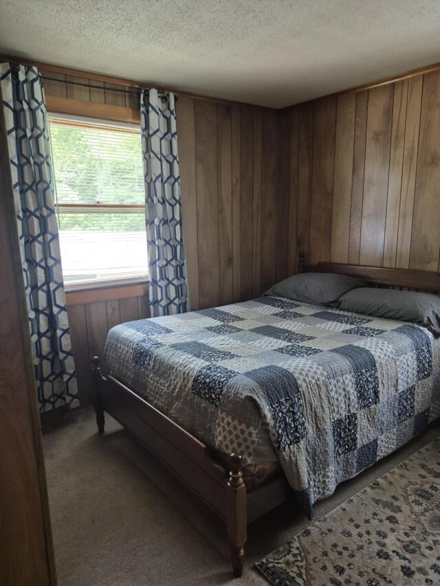 186 Hawes Ln, Union, ME 04862 - carpeted bedroom featuring a textured ceiling and wood walls