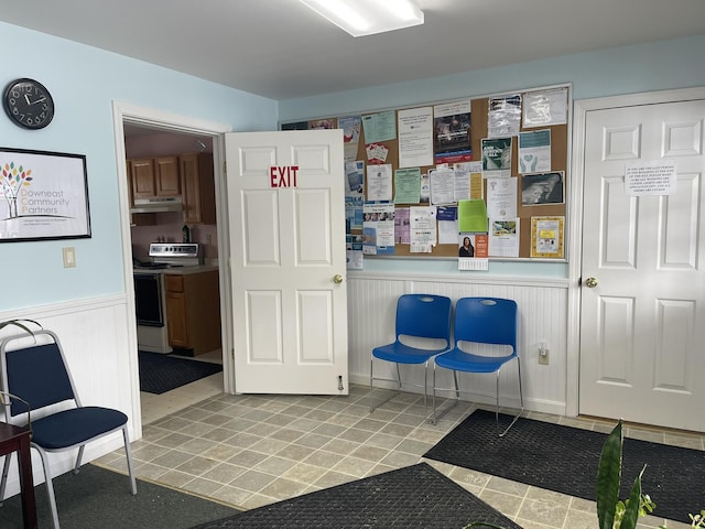 interior space with a wainscoted wall