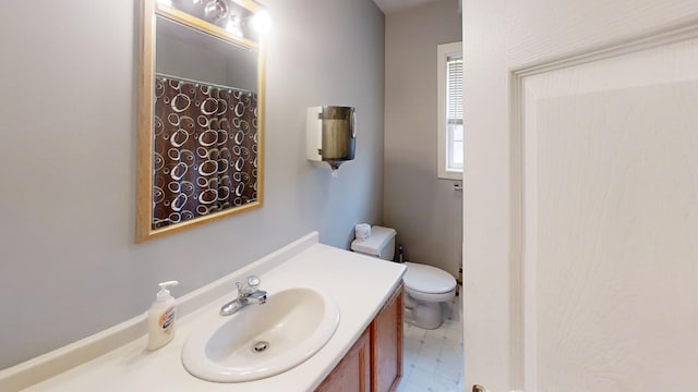 full bathroom featuring tile patterned floors, toilet, and vanity